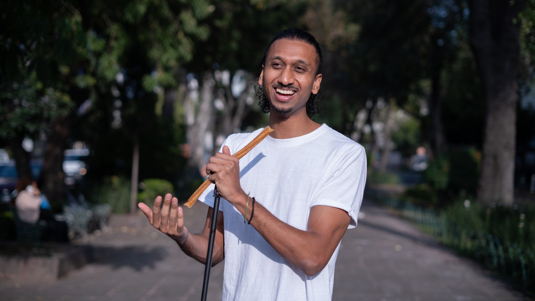 Rah Nimmy smiling outdoors during his portrait shoot